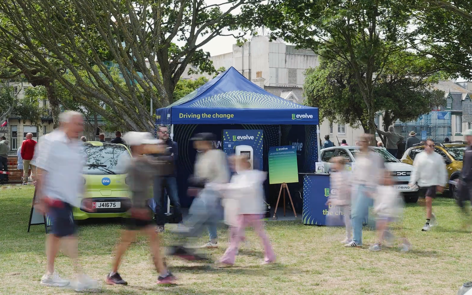 People walking past a blue